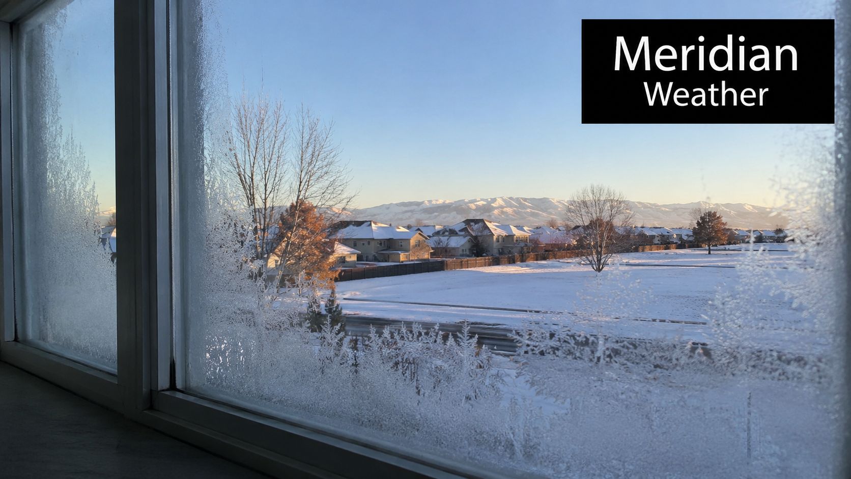 A view of a snowy neighborhood through a frost-covered energy-efficient window in Meridian, Idaho.